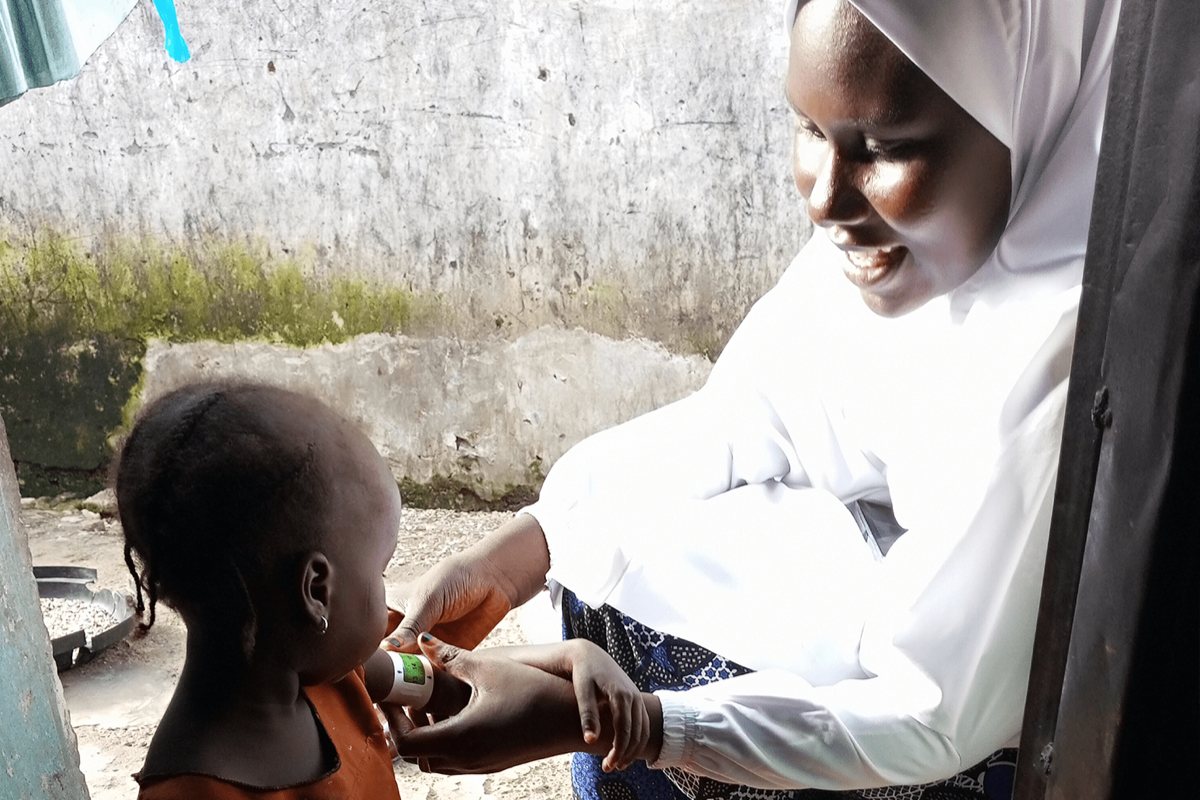 A Frontline Worker delivering child health services to a young child