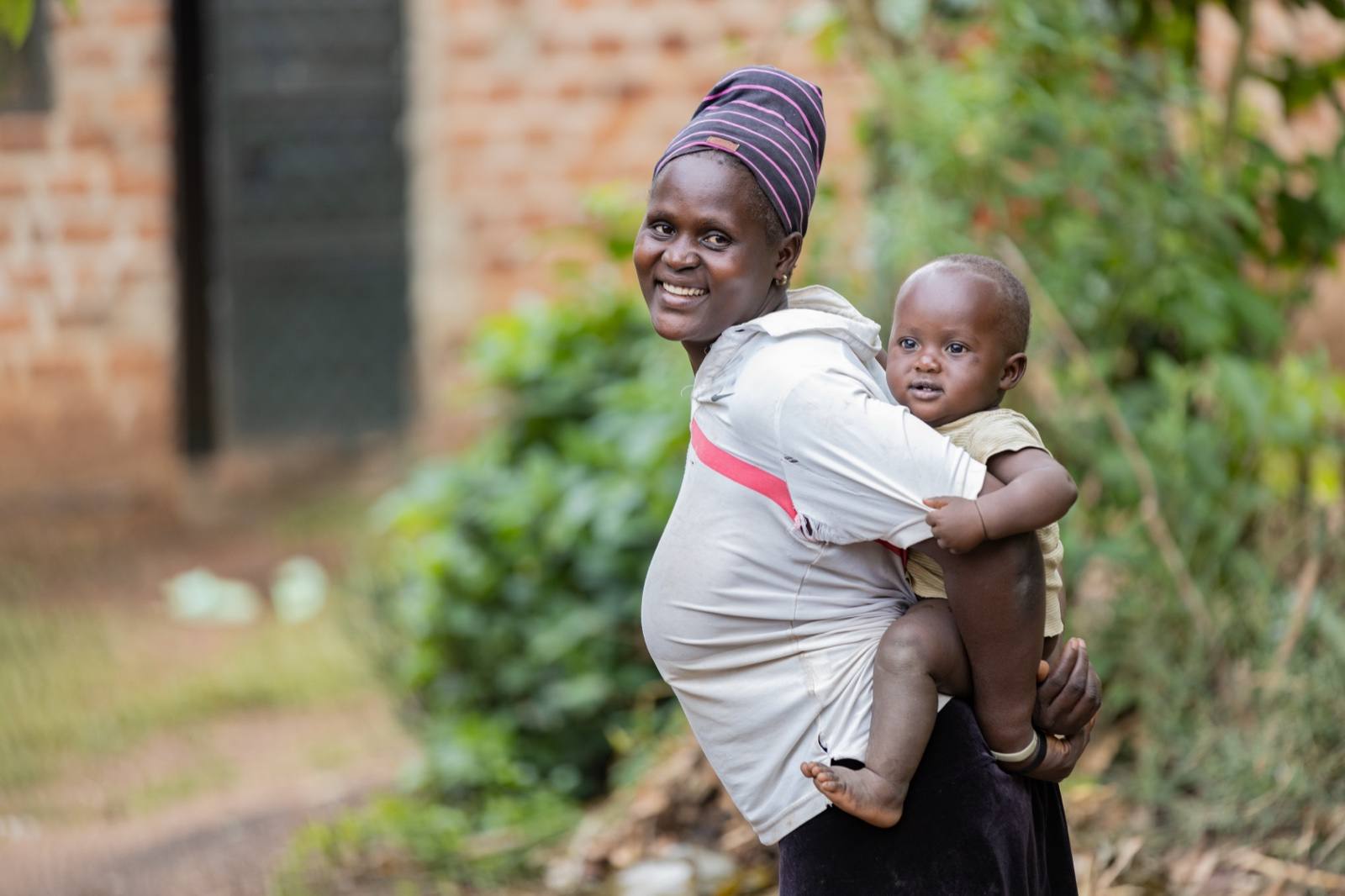 A mother carries her baby after receiving Kangaroo Mother Care guidance and support